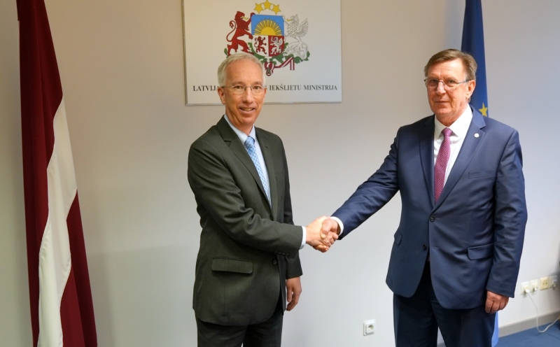 Iekšlietu ministrs un ASV vēstnieks Latvijā sarokojas